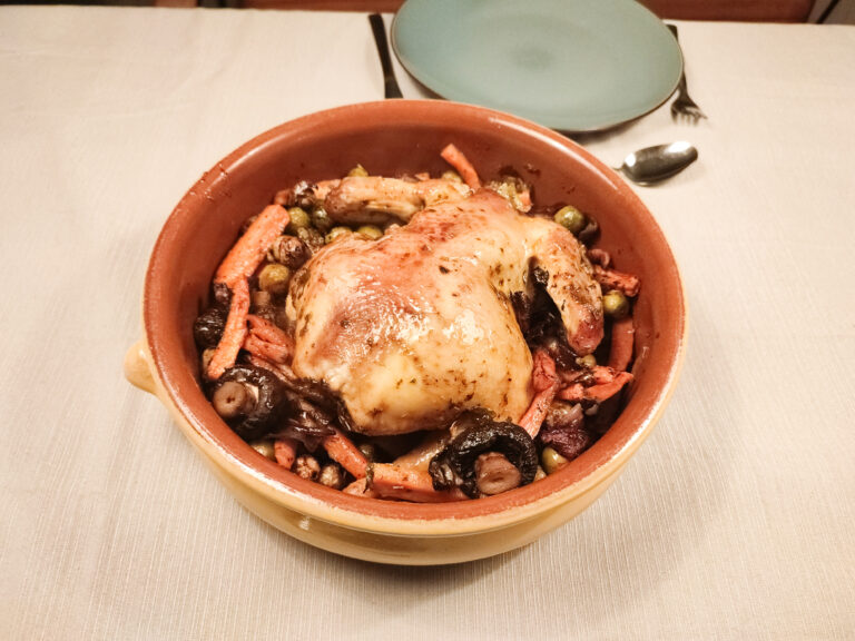 Spiced Herb Butter Roast Chicken with Vegetables with a green plate with cutlery