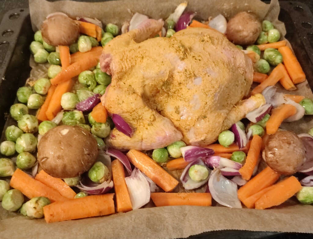 Spiced Herb Butter Roast Chicken with Vegetables before baking in a pan