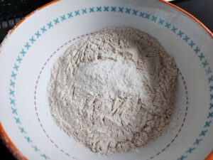 Sifted All Purpose Flour, Baking Powder and Salt in a white bowl