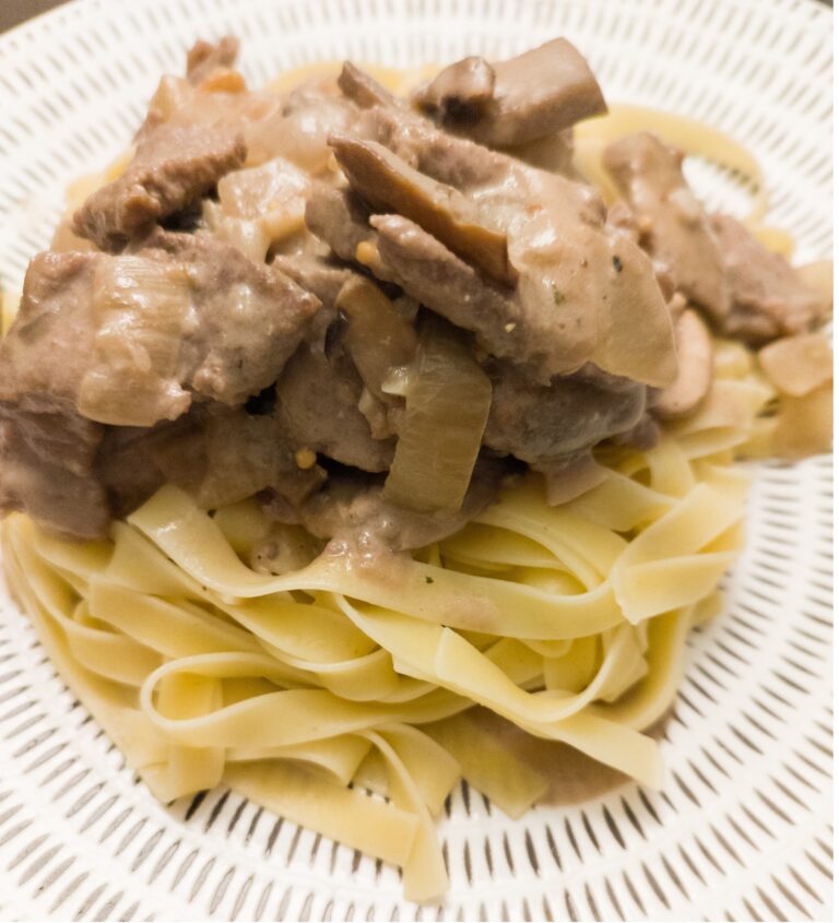 Beef Stroganoff with tagliatelle on a patterned serving plate