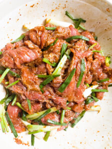 Beef marinade mixture in a large bowl (after)