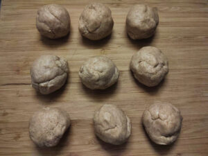 Divided dough balls on a rolling board