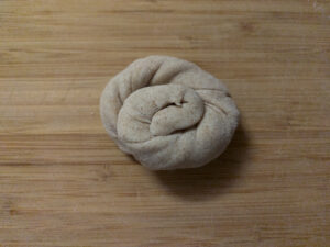 Coiled dough tube on a rolling board