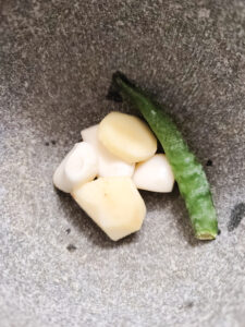 Garlic, ginger and green chilli in a mortar