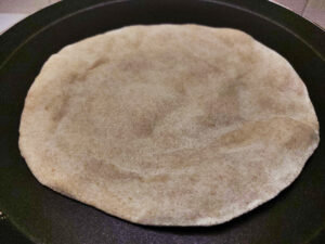 Hot pockets formed on partially cooked chapati cooking on a pan