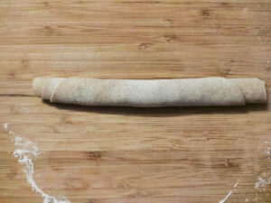 Rolled dough tube on a rolling board