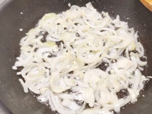 Sauteed onions cooked until translucent in a pan