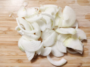 Sliced onions on a chopping board