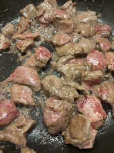 Stir frying beef in a pan