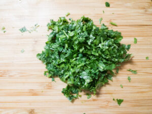 Finely chopped cilantro on a cutting bord