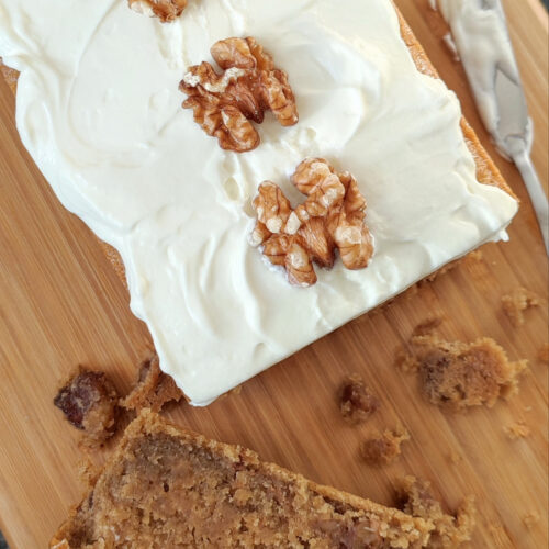 Coffee Walnut Mascarpone cake with Mascorpone Whipped Cream close up with a slice of it on the side