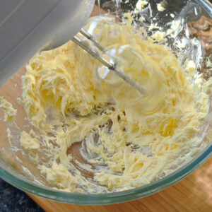 Creaming butter in a bowl with a hand mixer