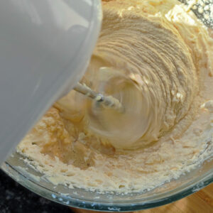 Incorporating one of third coffee into the cake batter using a hand mixer