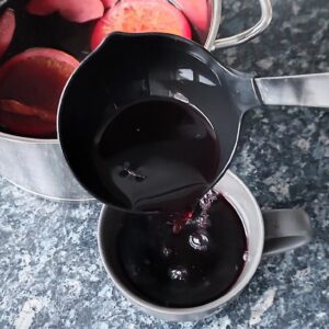 Ladling the Glühwein into a mug with a ladle