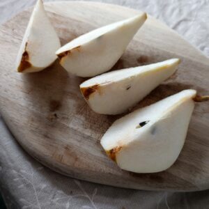 Quartered pear on a chopping board