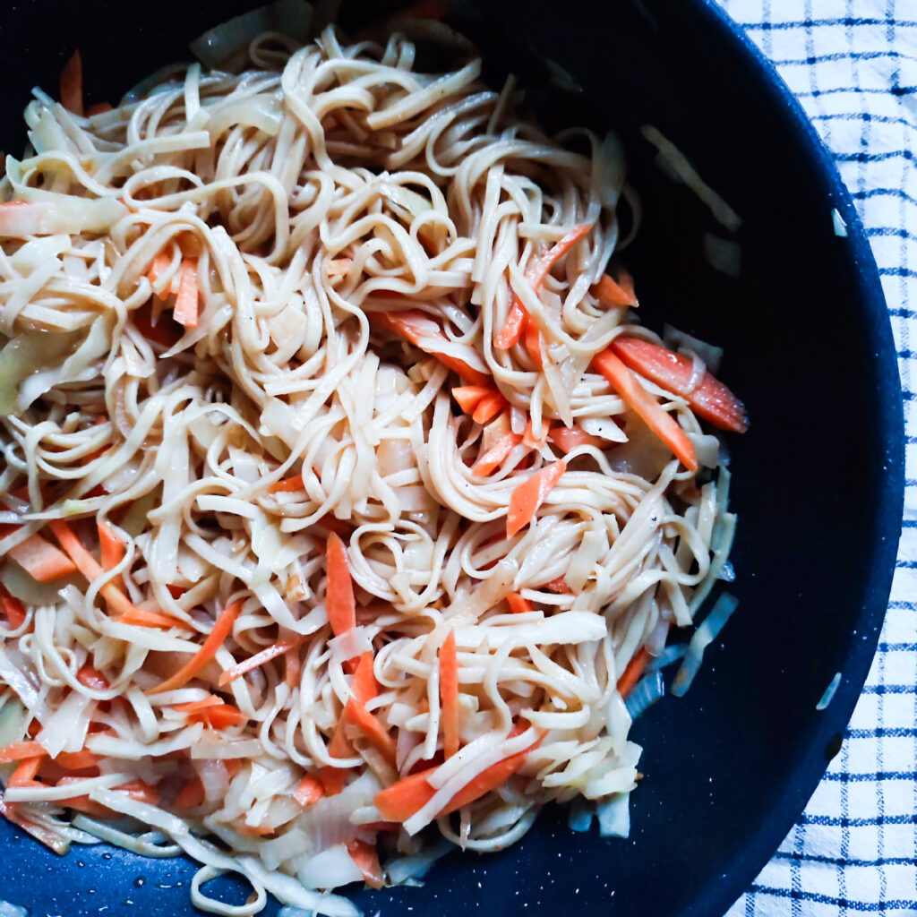 Stir Fry Yakisoba b-roll 1 : Stir Fry Yakisoba in a wok on checkered cloth