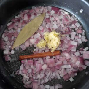 Adding ginger and garlic paste in the pan