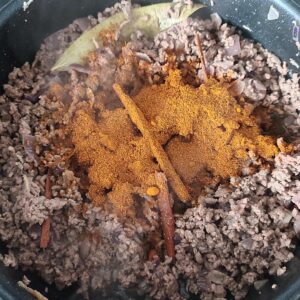 Adding keema spice in the pan