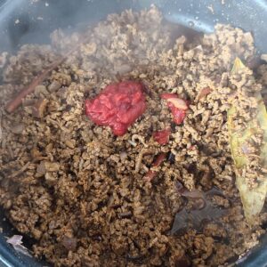 Adding tomato paste in the pan