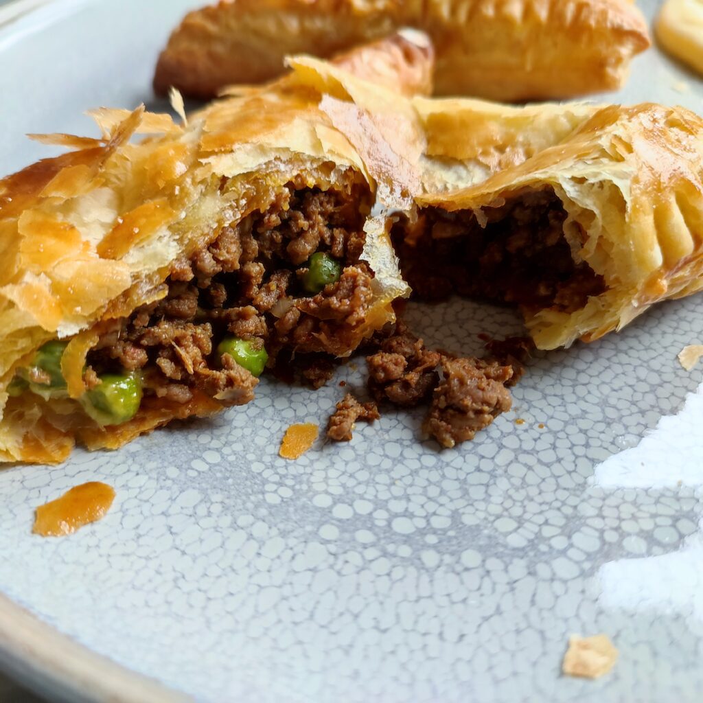 B roll 2 : Tore Cheesy Keema Puffs on a large gray plate