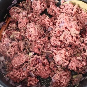 Breaking up the meat clumps in the pan