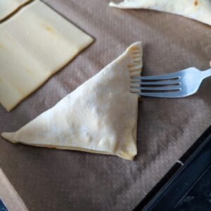 Crimp the all over the sides of the pastry with a fork on a lined baking tray