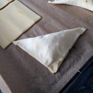 Pinch the sides of the pastry on a line baking tray