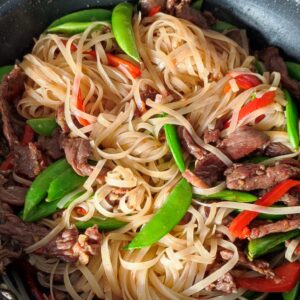 Stir Frying beef noodles in a wok