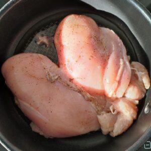 Seasoned chicken fillet pan frying on a pan