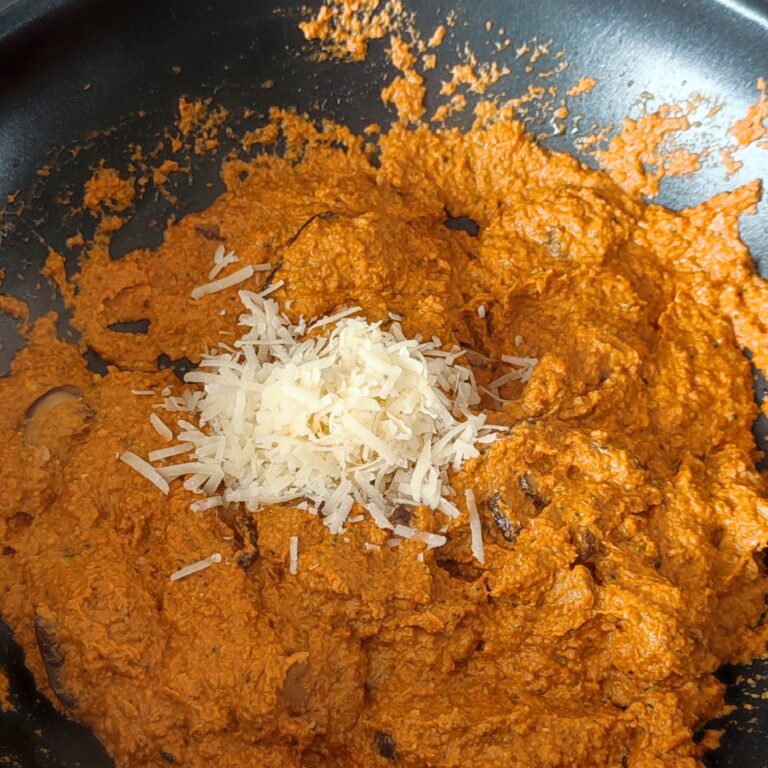 Adding shredded parmigiano reggiano in the pan