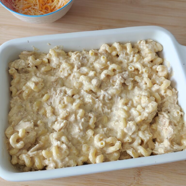 Unbaked mac and cheese in a casserole dish on a working surface