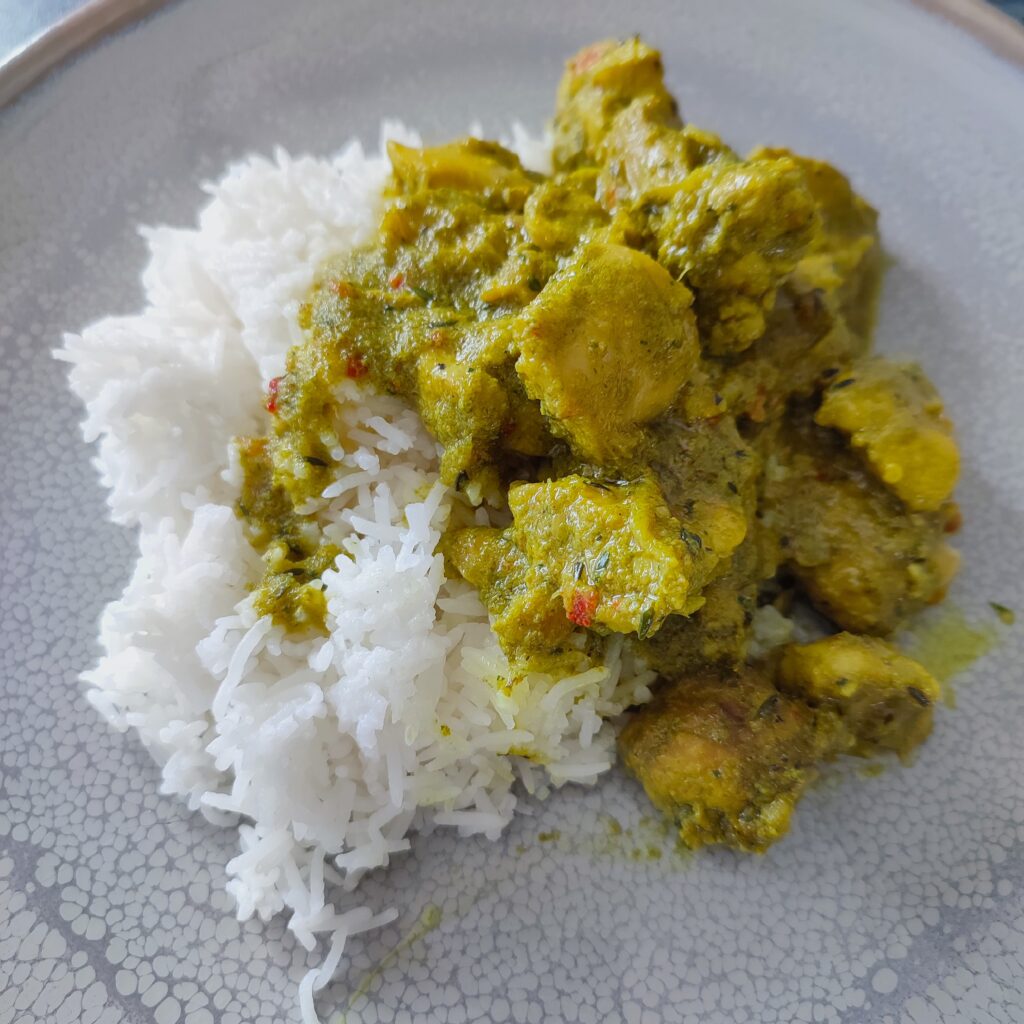 B roll 1 Trinidad Curry Chicken on white rice served on a large gray plate