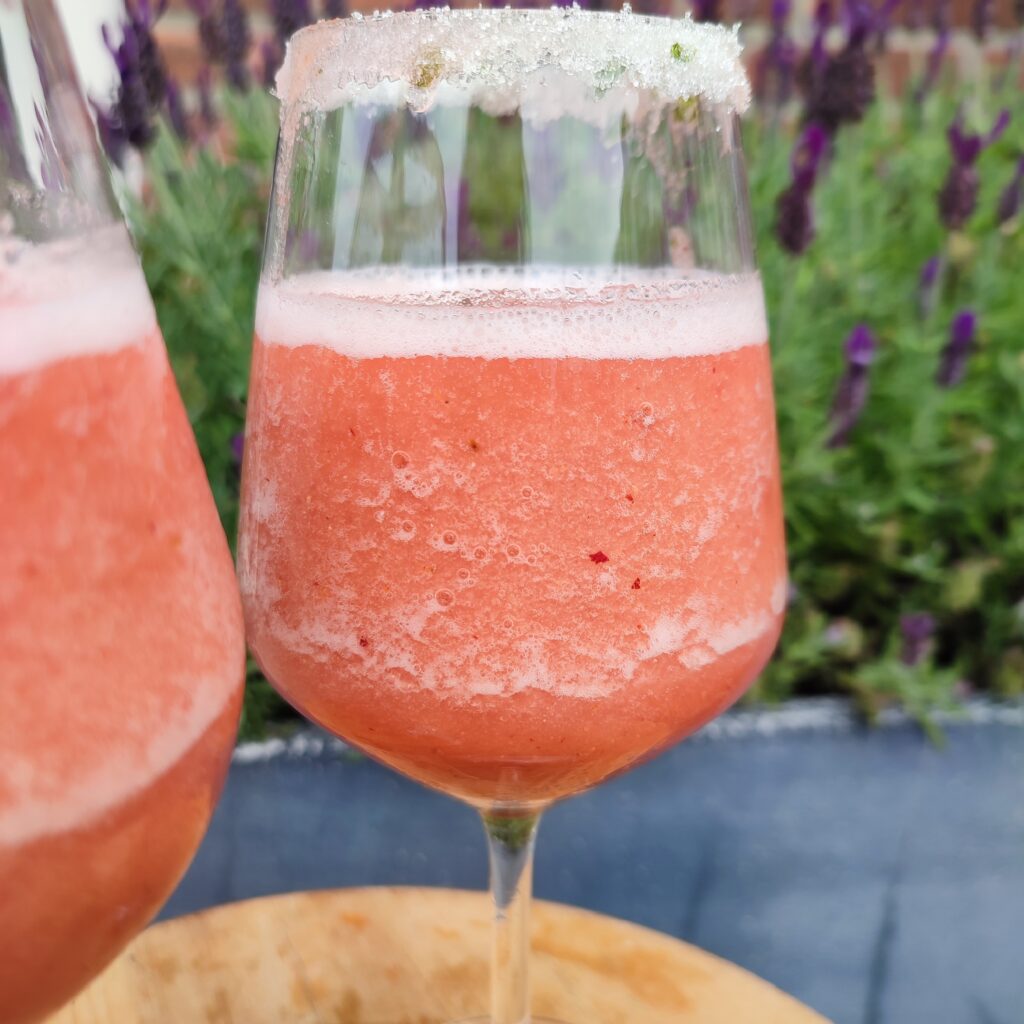 B roll 1 : Frosé Punch in wine glasses with the background of lavender flowers