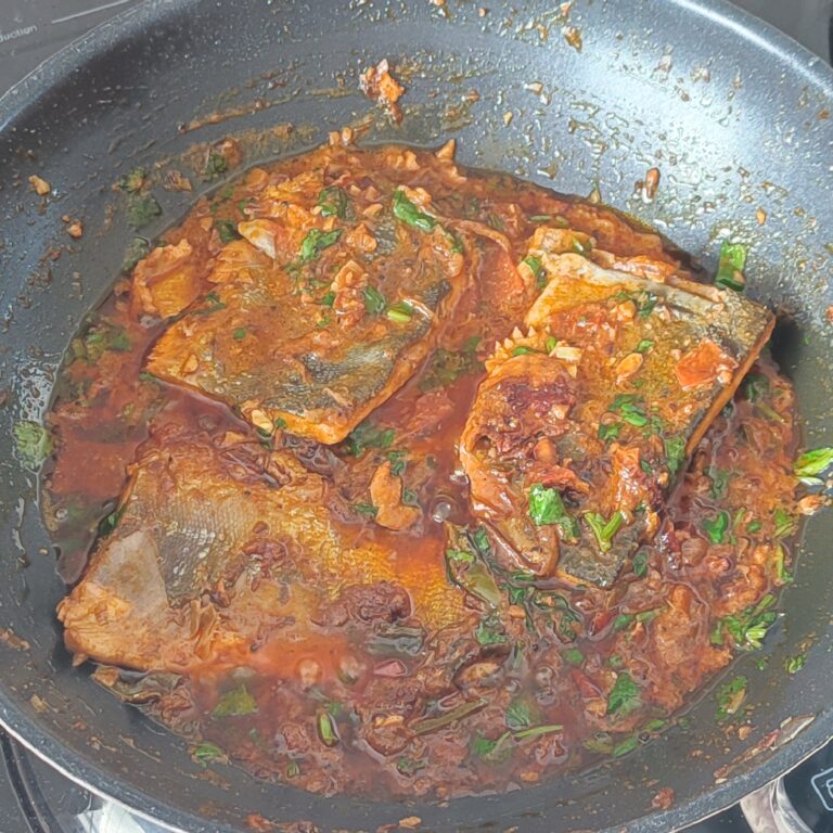 Cooked fish curry in a large pan