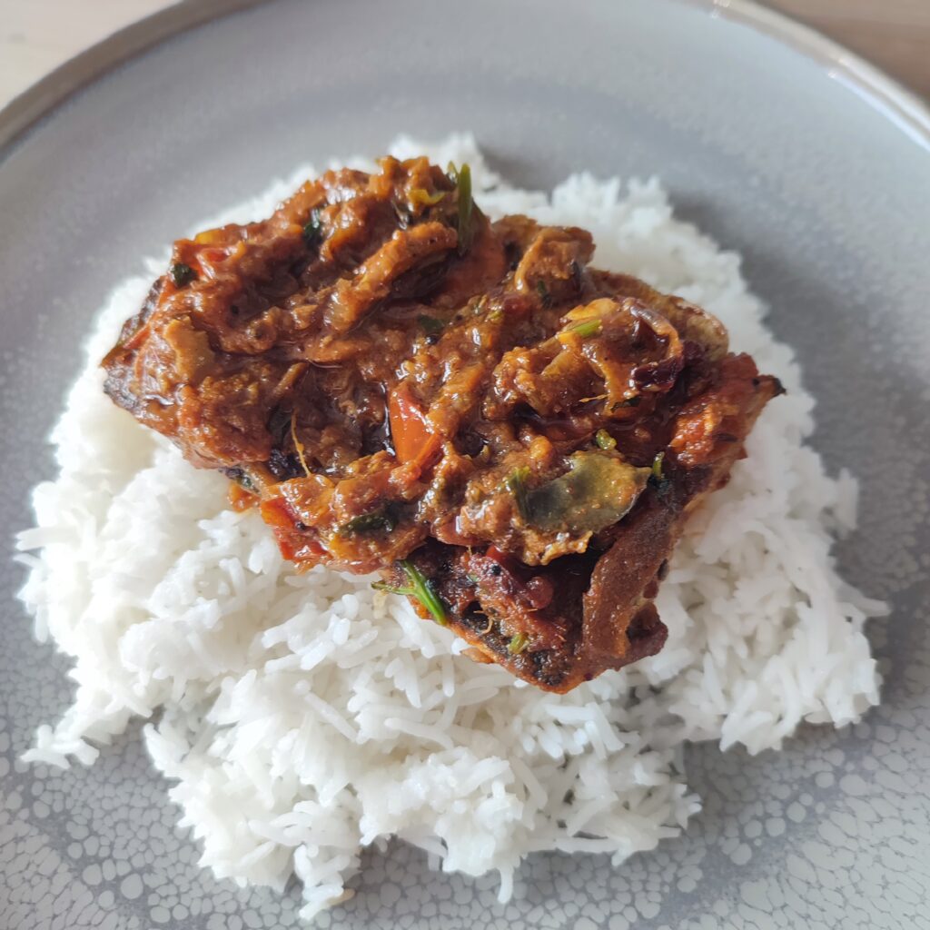 B roll 2 : South Indian Fish Curry on a bed of warm rice on a large gray plate