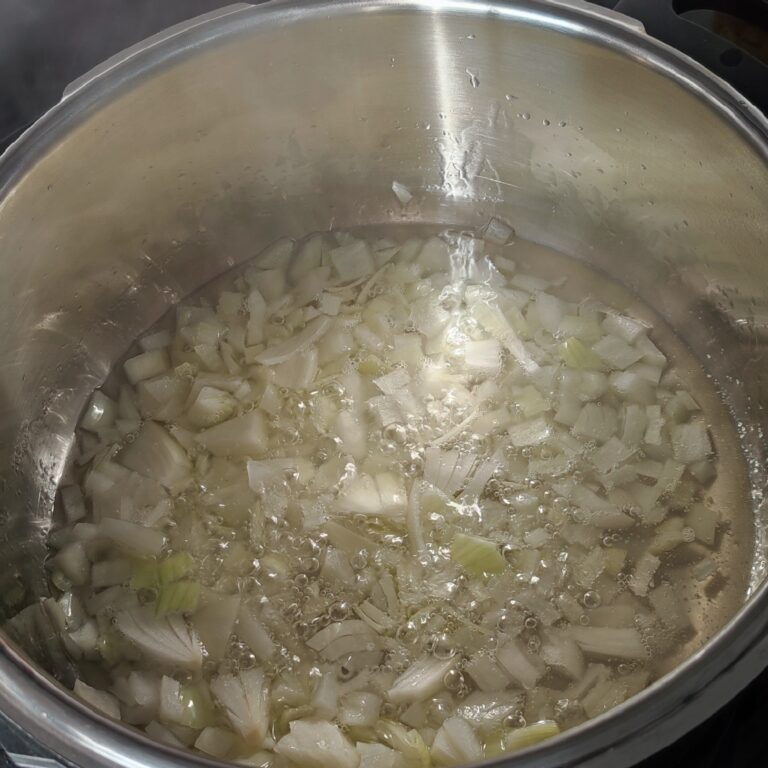 Diced onions sautéing in a pot