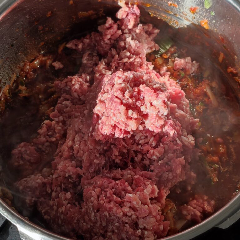 Adding minced beef to the pot