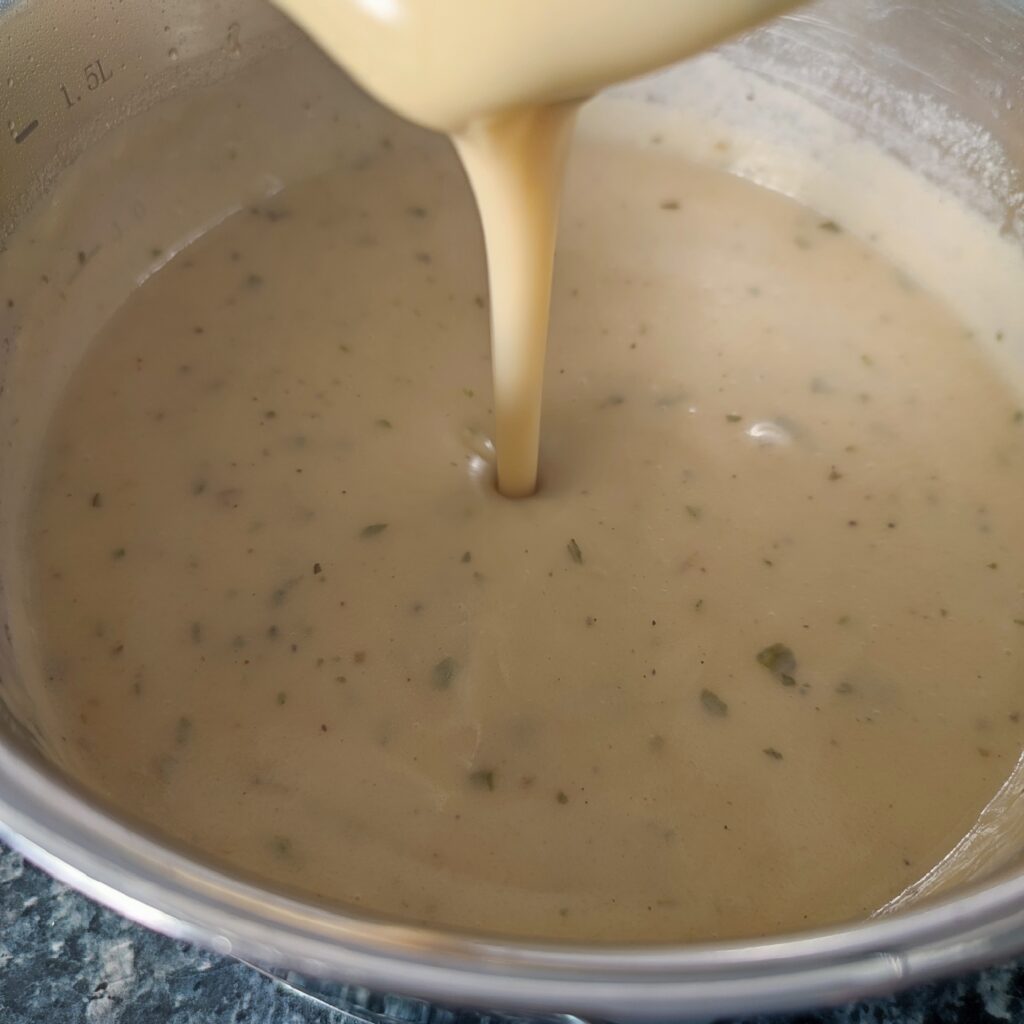 B shot 2: Pouring a ladle of Classic Christmas Gravy into the shallow pan full of it