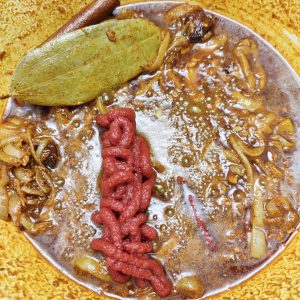 Adding tomato paste to the spice mix in a Dutch oven