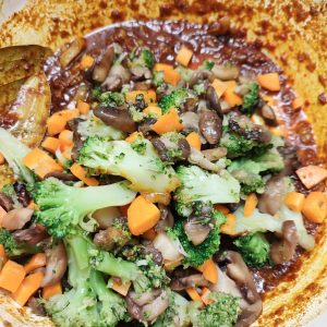 Adding vegetable to the tomato spice mix in a Dutch oven