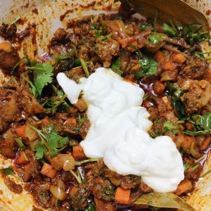 Adding yoghurt to the spice vegetable mix in a Dutch oven