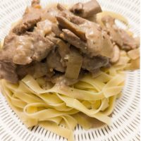 Beef Stroganoff with tagliatelle on a patterned serving plate