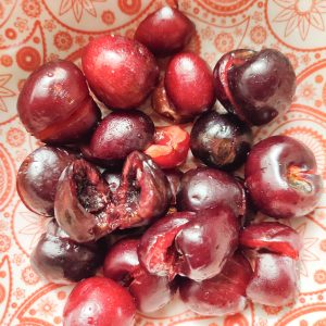 Black cherries (pitted) in a red patterned bowl