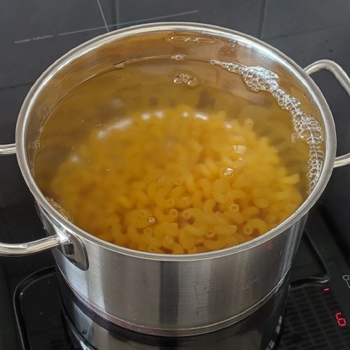 Cooking celentani pasta in a pot on the stove