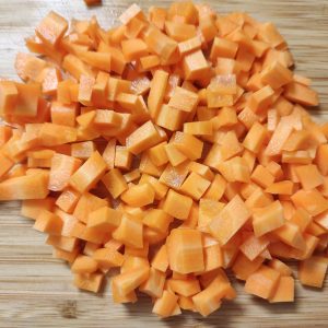 Cubed carrots on a cutting board