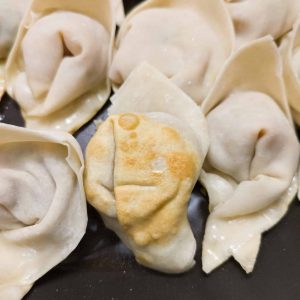 Golden brown on the bottom of the potstickers in a shallow frying pan