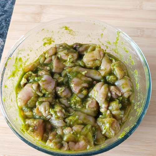 Marinade Mixture mixed with chicken pieces in a large bowl on a working surface