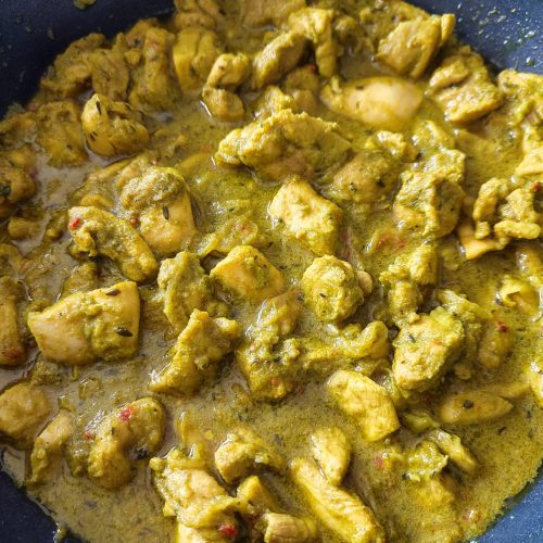 Ready to serve trinidad curry chicken in a pan