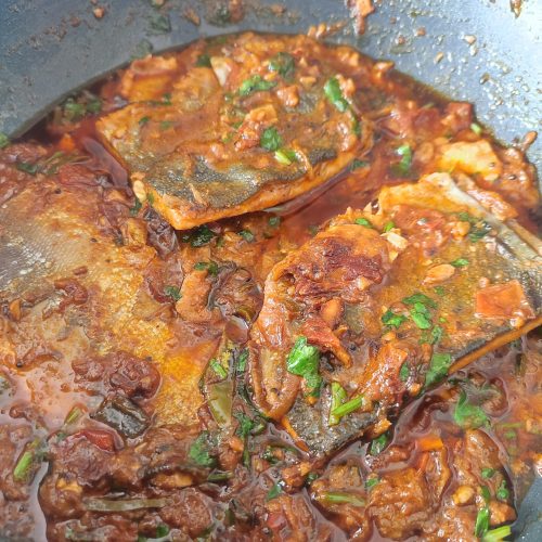 Ready to serve South Indian Fish Curry in a large pan