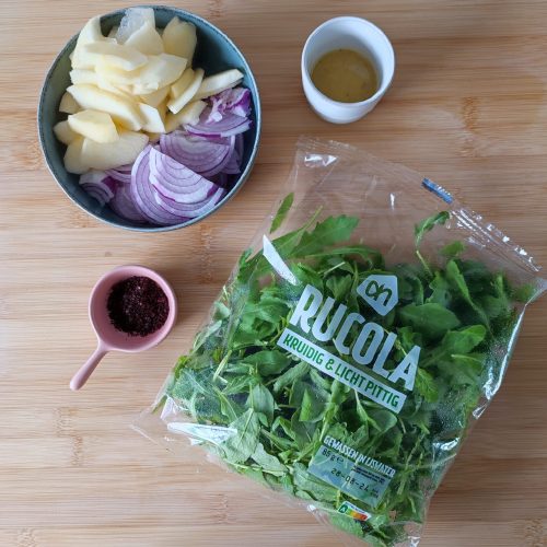 All ingredients for Apple Arugula Sumac Salad on the working surface